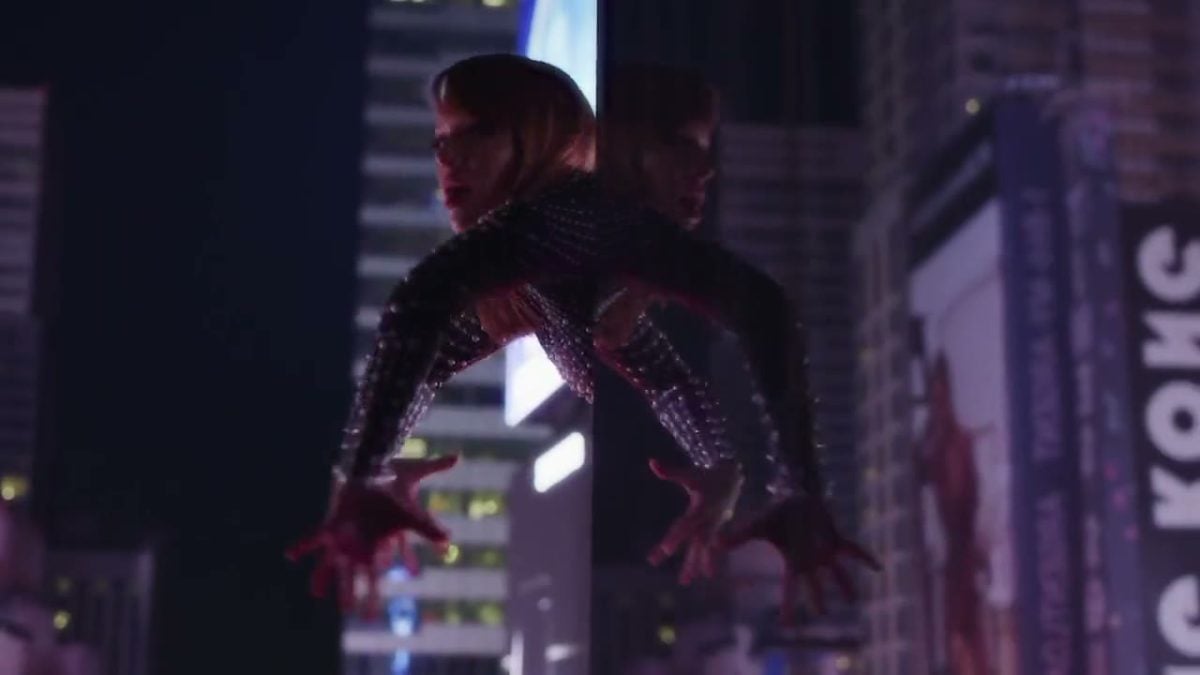 A person in a bodysuit crawls on a New York Skyscraper