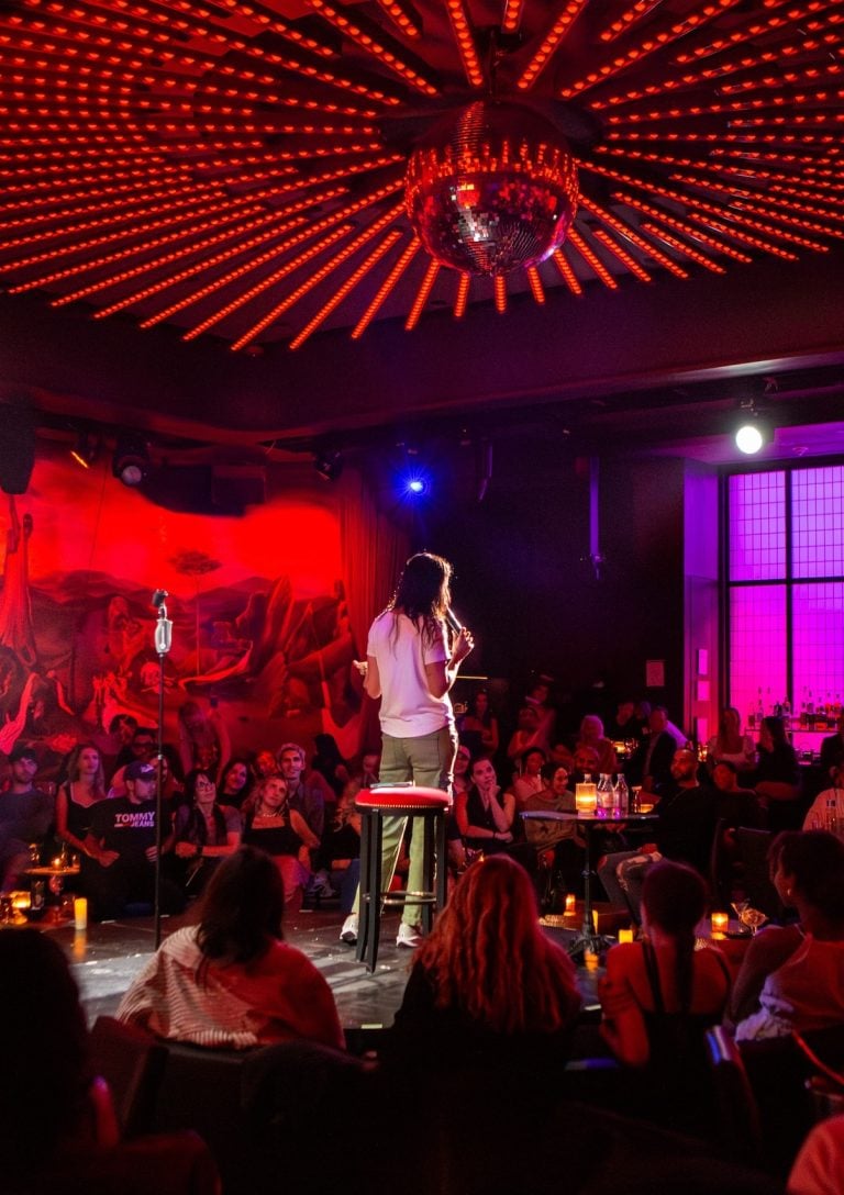 A comedian performs in the round at the Paradise Club
