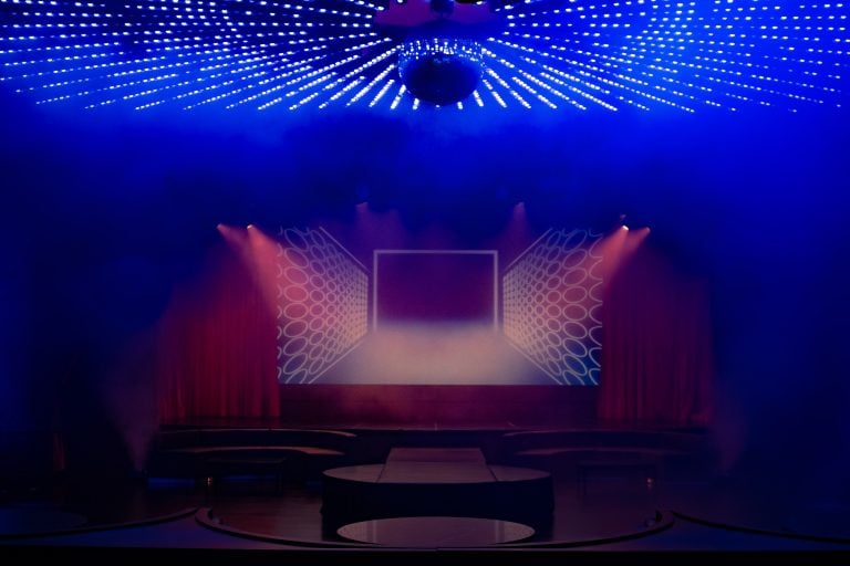A screen projection on stage at the Paradise Club