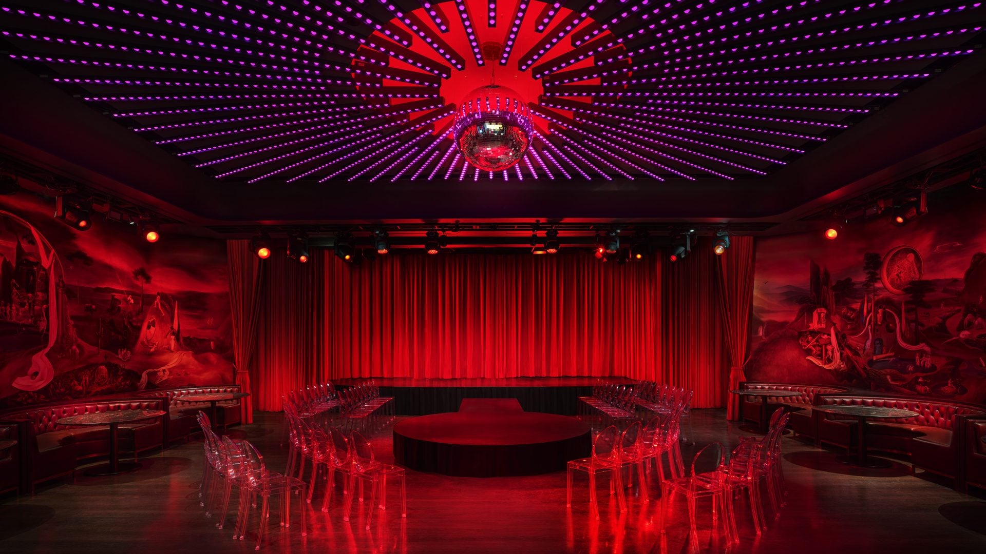 a stage surrounded by clear chairs at the Paradise Club in NYC